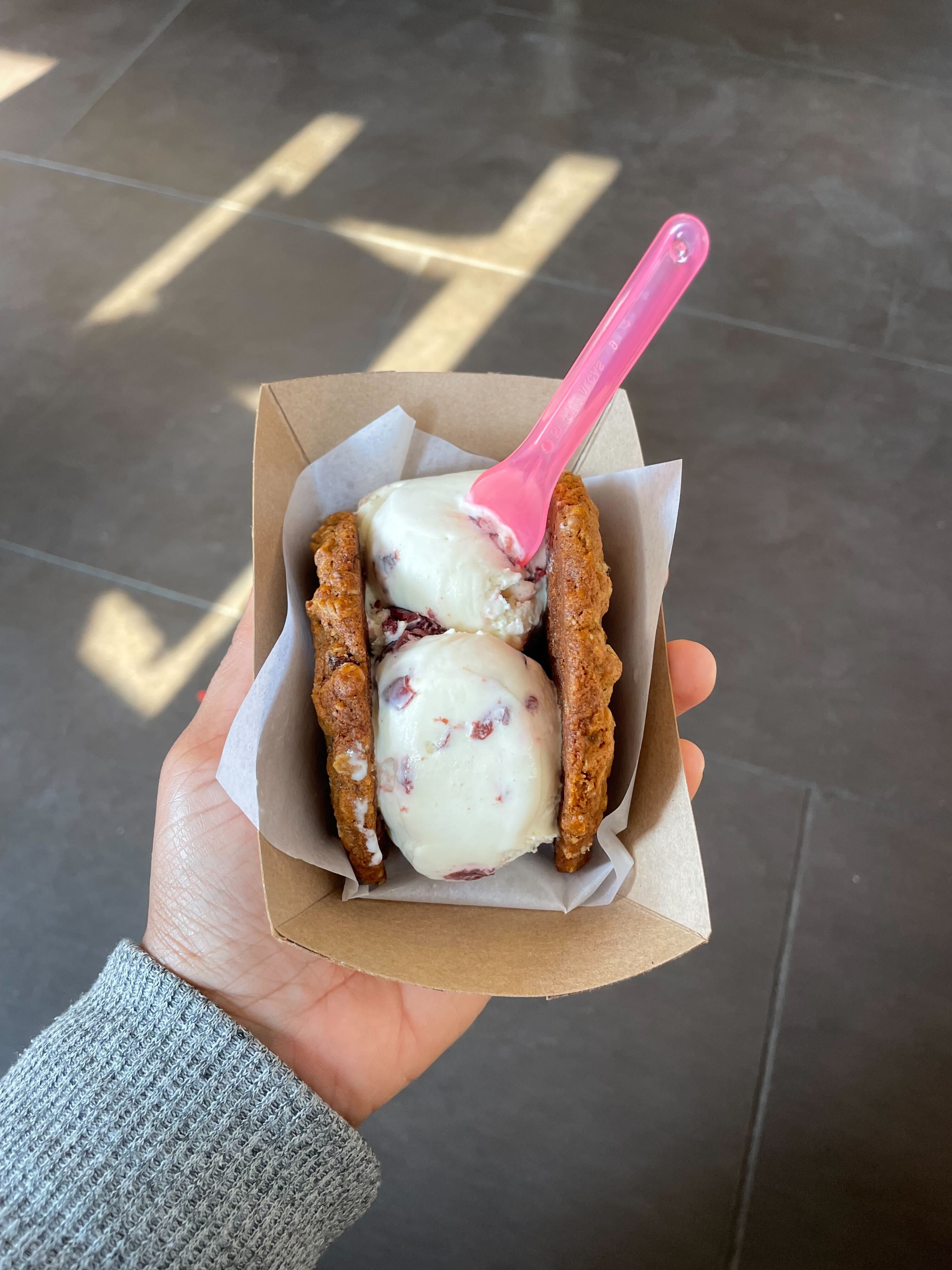 Me holding an ice cream sandwich in a paper bowl