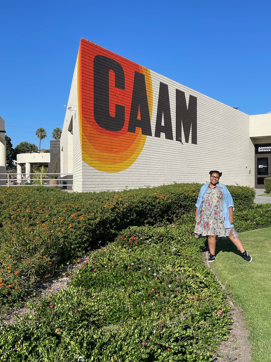Me outside of a museum that reads CAAM painted on the back wall